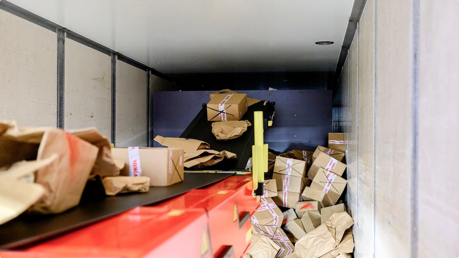 Operator loading parcels using ErgoRider platform